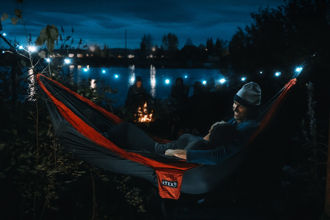 Man and woman sharing DoubleNest at night using Twilights Camp Lights.